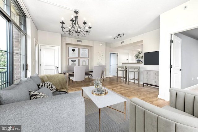 1111 25th St NW Unit 521, Washington, DC 20037 - living room featuring a chandelier, wood finished floors, and track lighting