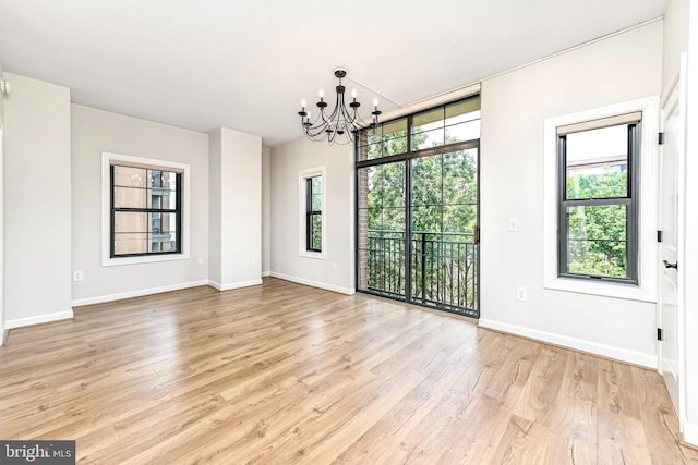 1111 25th St NW Unit 521, Washington, DC 20037 - empty room with a chandelier and light wood-type flooring
