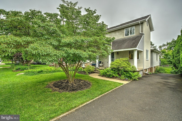 20 Grove Ave, Flourtown, PA 19031 - view of front of house with stucco siding and a front yard