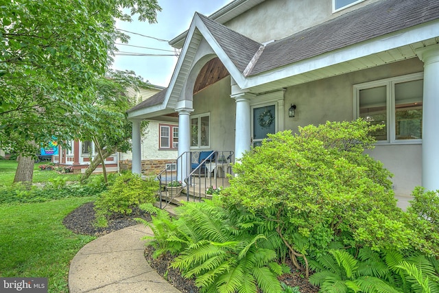 20 Grove Ave, Flourtown, PA 19031 - view of exterior entry featuring stucco siding and a shingled roof