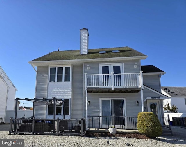 1 Lighthouse Cv, Brigantine, NJ 08203 - back of property with a balcony, a chimney, and a pergola