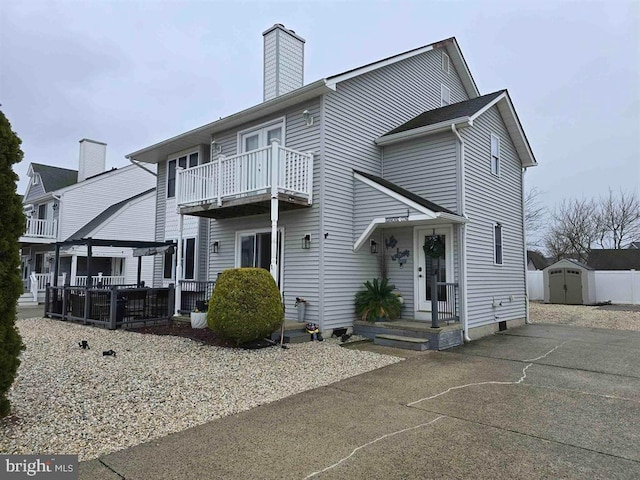 1 Lighthouse Cv, Brigantine, NJ 08203 - back of house featuring a storage shed, a balcony, a chimney, and a patio area