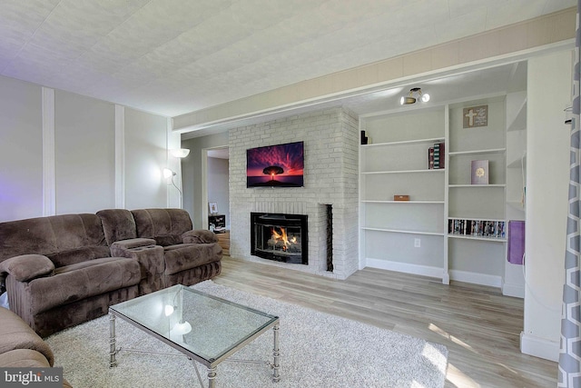 1326 Balsam St, Saint Leonard, MD 20685 - living area featuring wood finished floors, a brick fireplace, and built in features