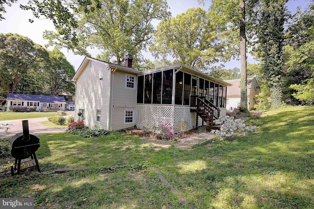 1326 Balsam St, Saint Leonard, MD 20685 - rear view of property with a sunroom, a lawn, and a chimney