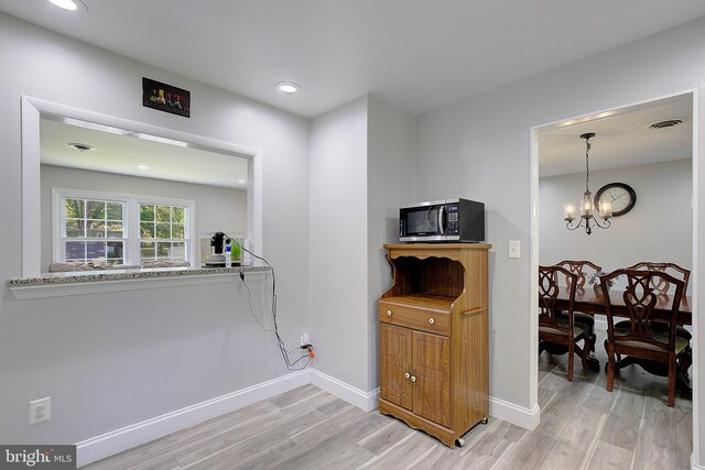 1326 Balsam St, Saint Leonard, MD 20685 - kitchen with light wood finished floors, a chandelier, recessed lighting, light stone countertops, and pendant lighting