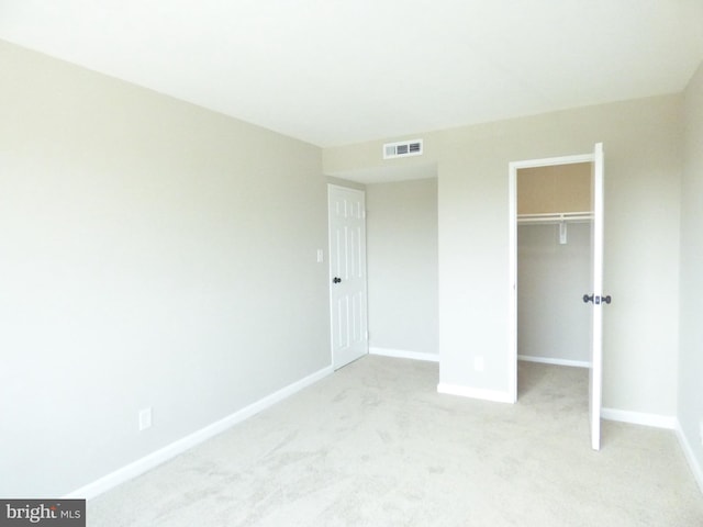 431 N Armistead St N Unit 311, Alexandria, VA 22312 - unfurnished bedroom with light colored carpet, a closet, and a walk in closet