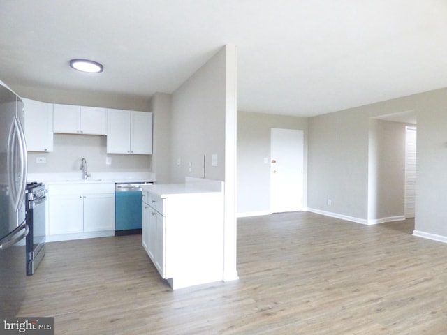 431 N Armistead St N Unit 311, Alexandria, VA 22312 - kitchen featuring appliances with stainless steel finishes, light countertops, light wood-style floors, and white cabinetry