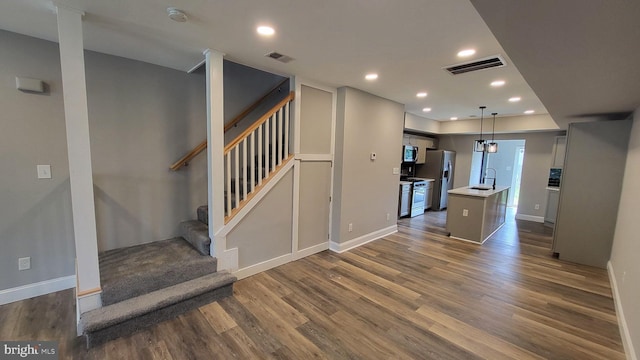 714 Green St, Havre De Grace, MD 21078 - kitchen featuring dark wood-type flooring, stainless steel appliances, light countertops, a kitchen island with sink, and recessed lighting