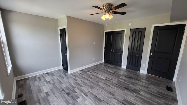 714 Green St, Havre De Grace, MD 21078 - unfurnished bedroom with two closets, wood finished floors, and ceiling fan