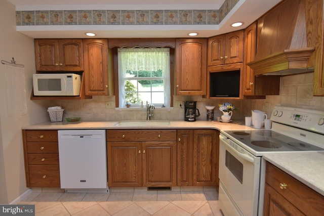 401 Antietam Rd, Reading, PA 19606 - kitchen with white appliances, custom range hood, brown cabinetry, decorative backsplash, and recessed lighting