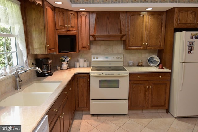 401 Antietam Rd, Reading, PA 19606 - kitchen with white appliances, custom exhaust hood, decorative backsplash, brown cabinets, and recessed lighting