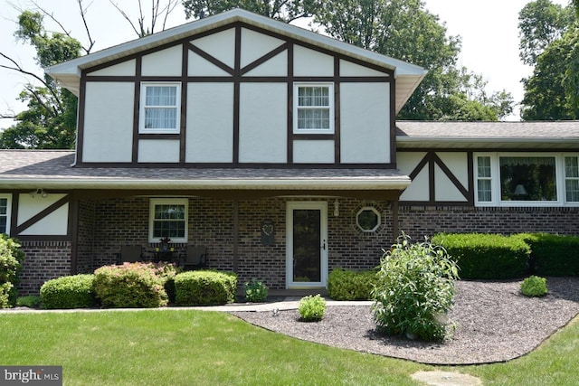 401 Antietam Rd, Reading, PA 19606 - tudor-style house featuring brick siding, stucco siding, roof with shingles, and a front yard