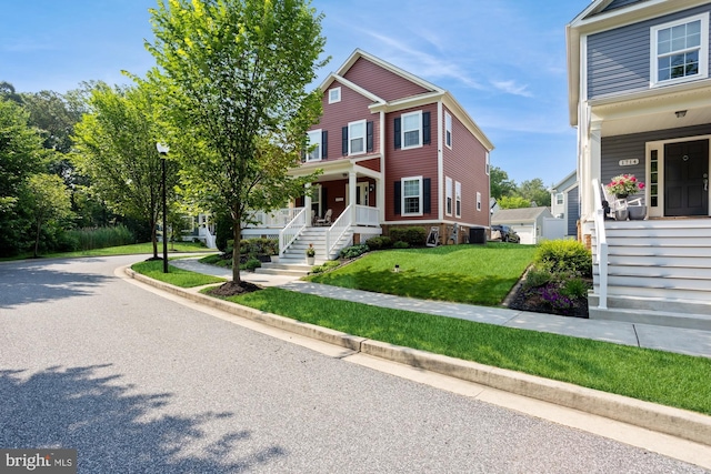 1712 Renaissance Dr, Baltimore, MD 21221 - view of front of property with covered porch, a front yard, and stairway