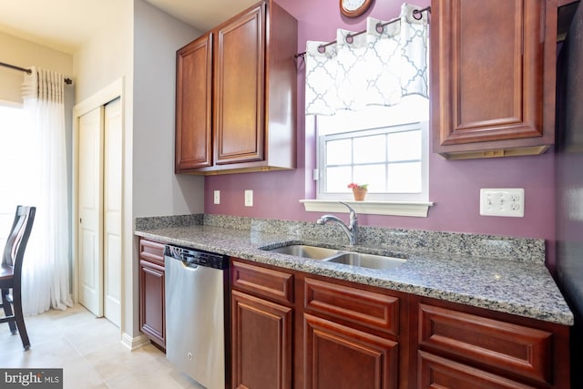 1712 Renaissance Dr, Baltimore, MD 21221 - kitchen featuring stainless steel dishwasher, light stone counters, and light tile patterned floors