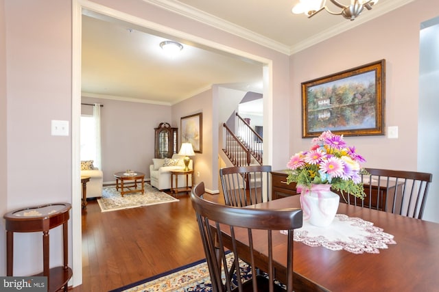 1712 Renaissance Dr, Baltimore, MD 21221 - dining area with wood finished floors, ornamental molding, a chandelier, and stairs