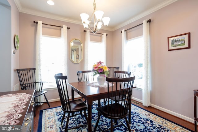 1712 Renaissance Dr, Baltimore, MD 21221 - dining area with dark wood-type flooring, a chandelier, ornamental molding, and plenty of natural light