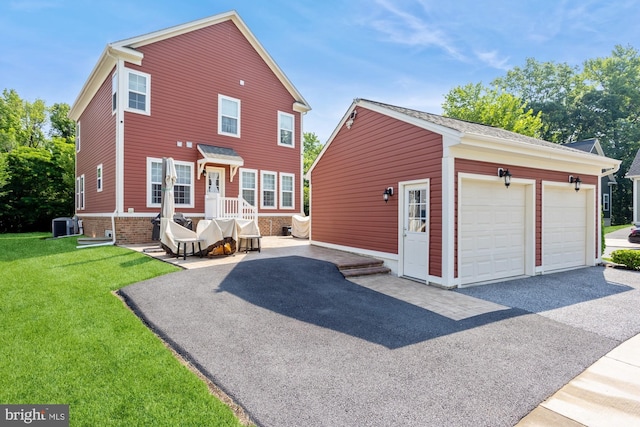 1712 Renaissance Dr, Baltimore, MD 21221 - rear view of property with an outbuilding, a lawn, a garage, and asphalt driveway