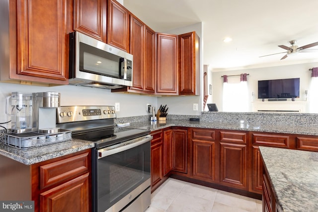 1712 Renaissance Dr, Baltimore, MD 21221 - kitchen with appliances with stainless steel finishes, dark brown cabinets, ceiling fan, and light stone counters