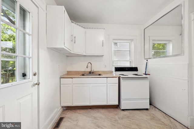 426 Summit St, Fredericksburg, VA 22401 - kitchen with electric stove, light marble finish flooring, white cabinets, and light countertops