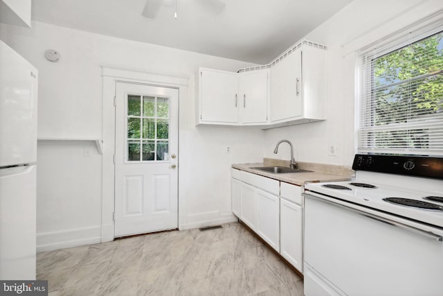 426 Summit St, Fredericksburg, VA 22401 - kitchen featuring white appliances, white cabinets, plenty of natural light, and light countertops