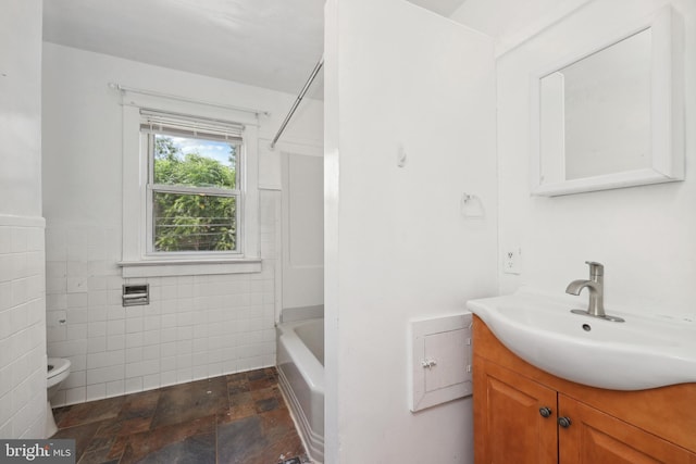 426 Summit St, Fredericksburg, VA 22401 - full bathroom with vanity, tile walls, stone finish flooring,  shower combination, and a wainscoted wall