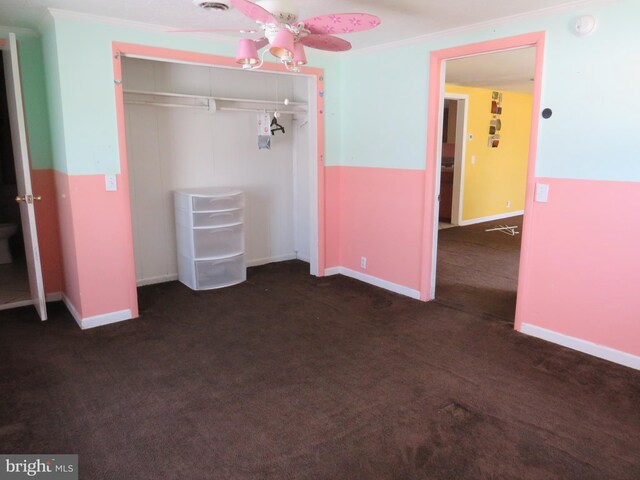 208 Cove St, Crisfield, MD 21817 - unfurnished bedroom with a closet, dark colored carpet, and crown molding