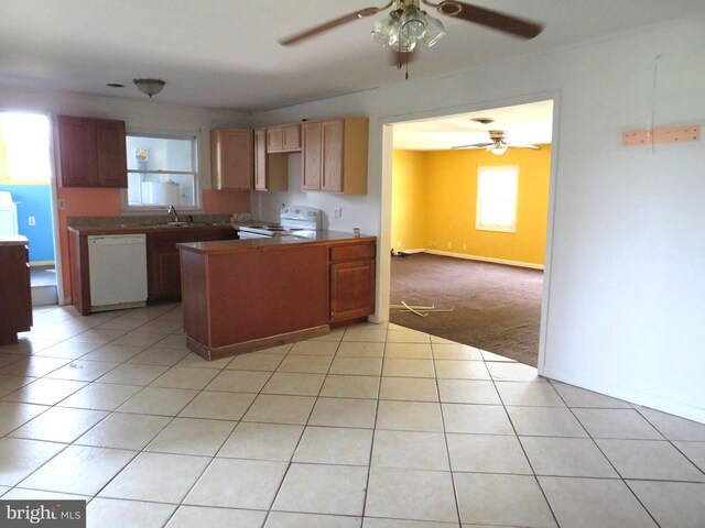 208 Cove St, Crisfield, MD 21817 - kitchen with white appliances, a ceiling fan, a peninsula, light tile patterned flooring, and light colored carpet