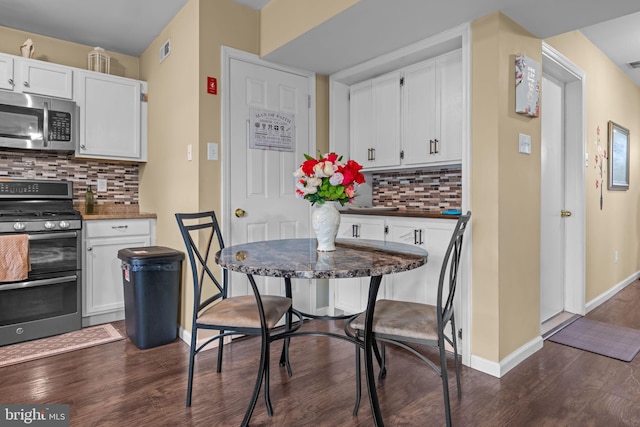2610 Daniels Ln, Quakertown, PA 18951 - kitchen with stainless steel appliances, dark wood finished floors, tasteful backsplash, and white cabinets