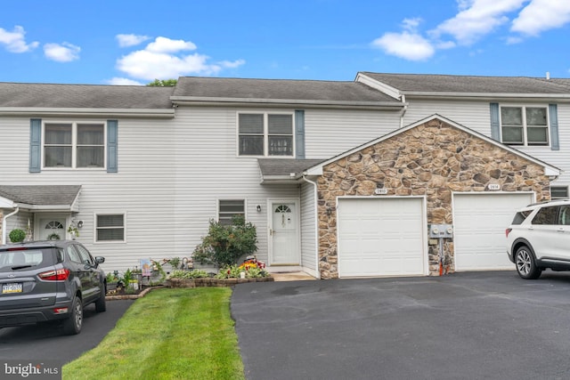 2610 Daniels Ln, Quakertown, PA 18951 - townhome / multi-family property featuring asphalt driveway, stone siding, an attached garage, and roof with shingles