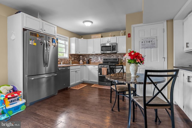 2610 Daniels Ln, Quakertown, PA 18951 - kitchen with appliances with stainless steel finishes, white cabinetry, dark wood finished floors, and tasteful backsplash