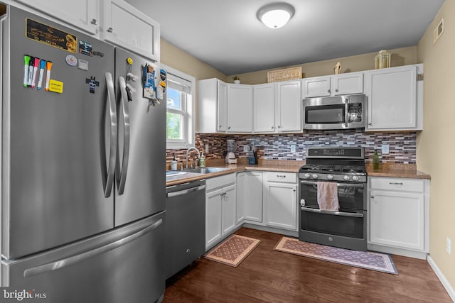 2610 Daniels Ln, Quakertown, PA 18951 - kitchen featuring stainless steel appliances, dark wood-style floors, decorative backsplash, and white cabinets