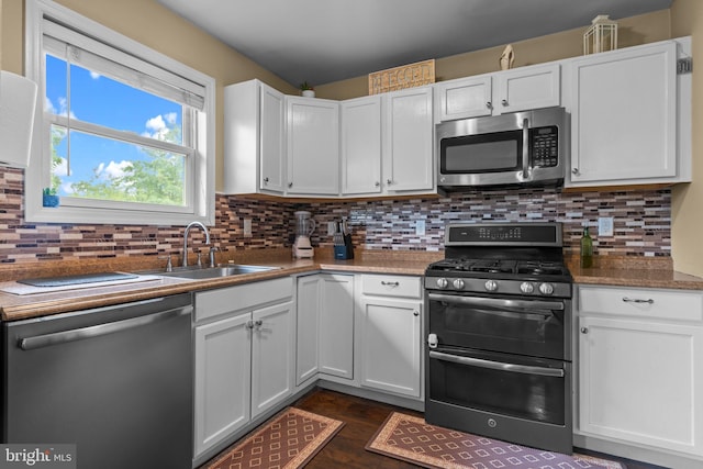 2610 Daniels Ln, Quakertown, PA 18951 - kitchen featuring stainless steel appliances, white cabinets, backsplash, and dark wood-style floors