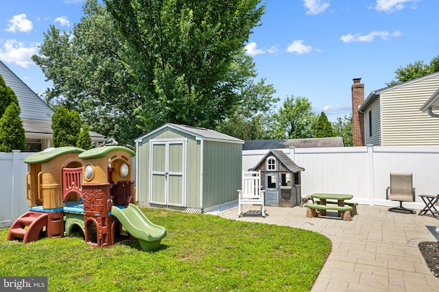143 Moore Ave, Barrington, NJ 08007 - fenced backyard with a storage unit, a patio, and a playground