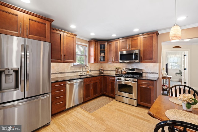 143 Moore Ave, Barrington, NJ 08007 - kitchen featuring stainless steel appliances, crown molding, light wood-type flooring, decorative backsplash, and glass insert cabinets