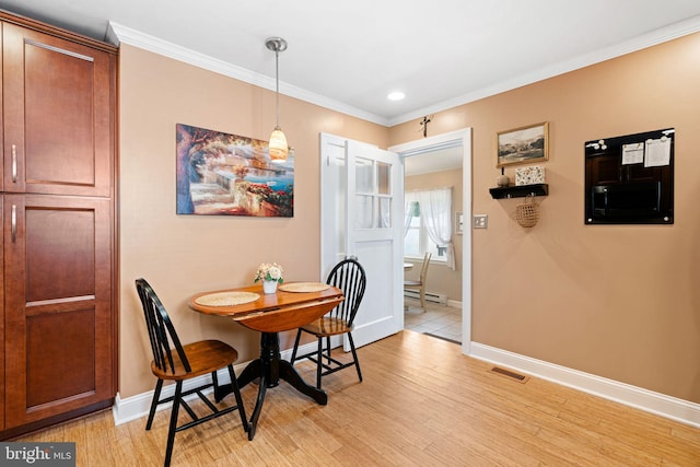 143 Moore Ave, Barrington, NJ 08007 - dining space with light wood-type flooring, crown molding, a baseboard heating unit, and recessed lighting