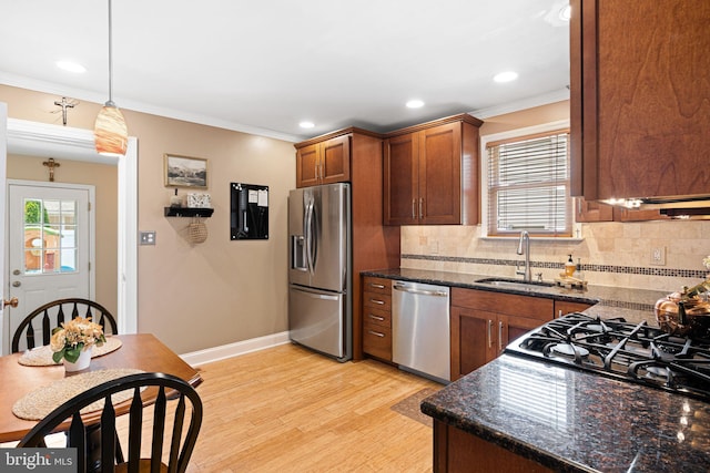 143 Moore Ave, Barrington, NJ 08007 - kitchen featuring stainless steel appliances, ornamental molding, light wood finished floors, decorative backsplash, and decorative light fixtures