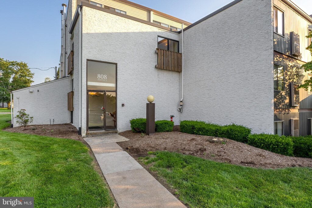 808 Stratford Dr Unit 12, State College, PA 16801 - view of front of home with stucco siding and a front yard
