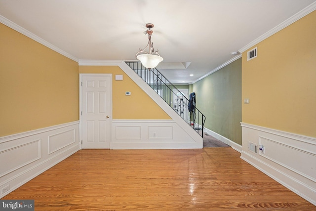 453 Hermitage St, Philadelphia, PA 19128 - interior space featuring crown molding, wood finished floors, stairway, wainscoting, and a decorative wall