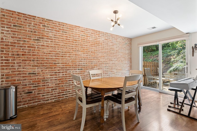 13 Summit Ct, Plymouth Meeting, PA 19462 - dining space with brick wall, wood finished floors, and a chandelier