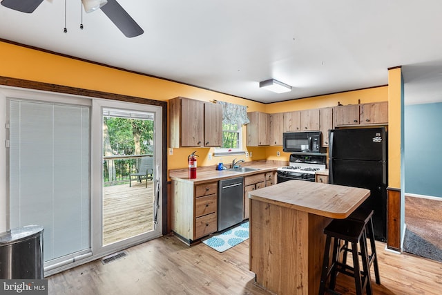 71 Winfield Rd, Sicklerville, NJ 08081 - kitchen with black appliances, light wood-style floors, a ceiling fan, and a center island