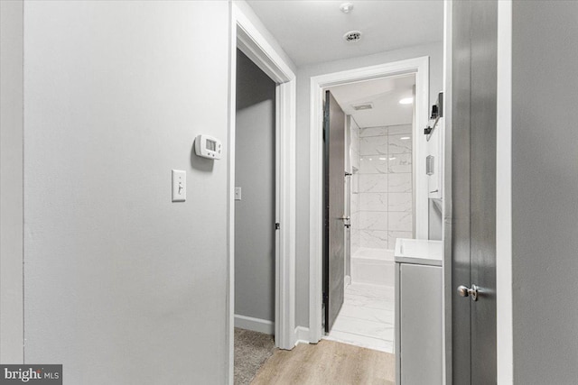 1801 Calvert St NW Unit 204, Washington, DC 20009 - corridor featuring baseboards and light marble finish flooring