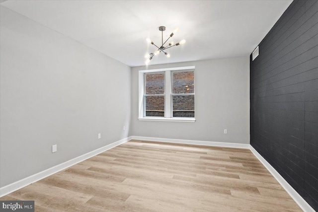 1801 Calvert St NW Unit 204, Washington, DC 20009 - spare room featuring a chandelier and light wood finished floors
