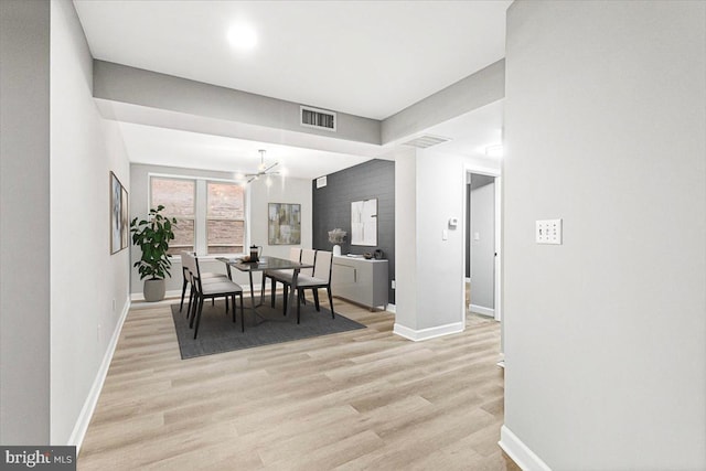 1801 Calvert St NW Unit 204, Washington, DC 20009 - dining area featuring light wood-style flooring and a chandelier