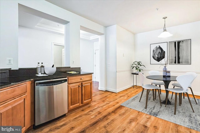2700 Willow Oak Dr Unit 111B, Cambridge, MD 21613 - kitchen with stainless steel dishwasher, light wood-style flooring, brown cabinetry, pendant lighting, and a raised ceiling
