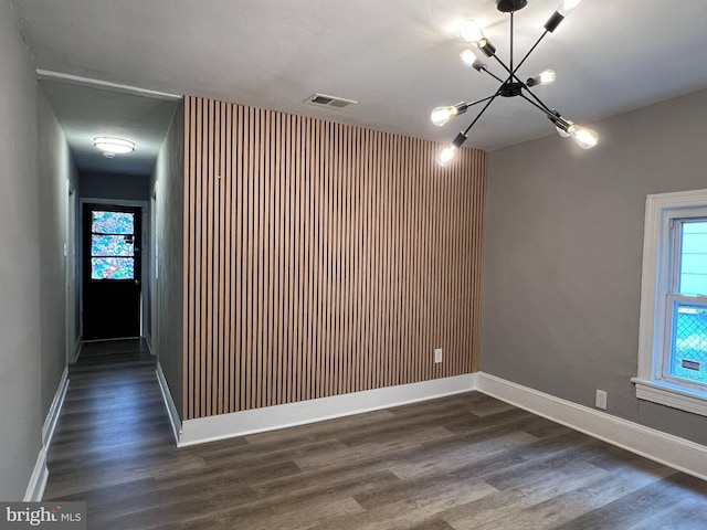6309 61st Pl, Riverdale, MD 20737 - empty room featuring a chandelier, dark wood-style flooring, and plenty of natural light