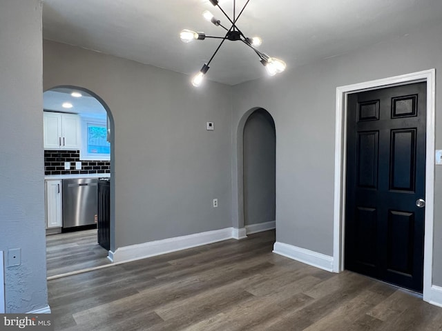 6309 61st Pl, Riverdale, MD 20737 - spare room with arched walkways, a chandelier, and wood finished floors