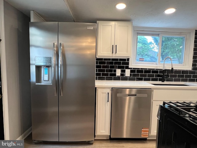 6309 61st Pl, Riverdale, MD 20737 - kitchen featuring stainless steel appliances, white cabinets, decorative backsplash, light countertops, and recessed lighting