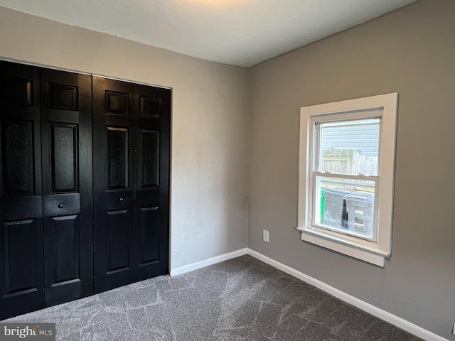 6309 61st Pl, Riverdale, MD 20737 - unfurnished bedroom featuring dark colored carpet and baseboards