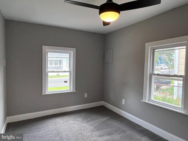 6309 61st Pl, Riverdale, MD 20737 - empty room featuring healthy amount of natural light, dark colored carpet, and a ceiling fan