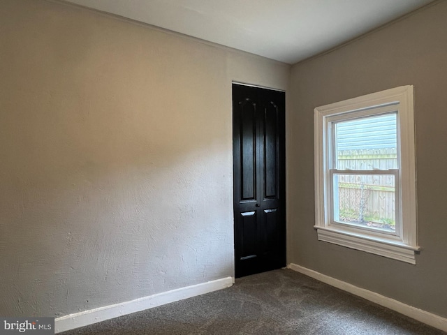 6309 61st Pl, Riverdale, MD 20737 - spare room with dark colored carpet and baseboards